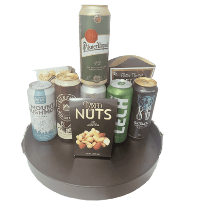 Beer gift basket with six international beers, pretzels, nuts, chips, and gourmet snacks, unwrapped and arranged for delivery in Calgary