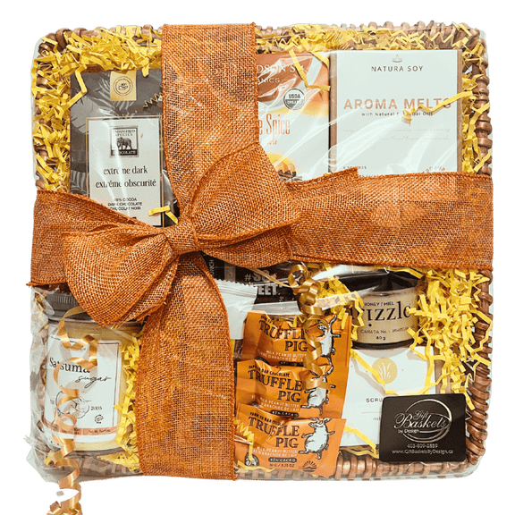 A spa gift basket containing a variety of gourmet treats and spa products, neatly arranged and tied with an orange ribbon.