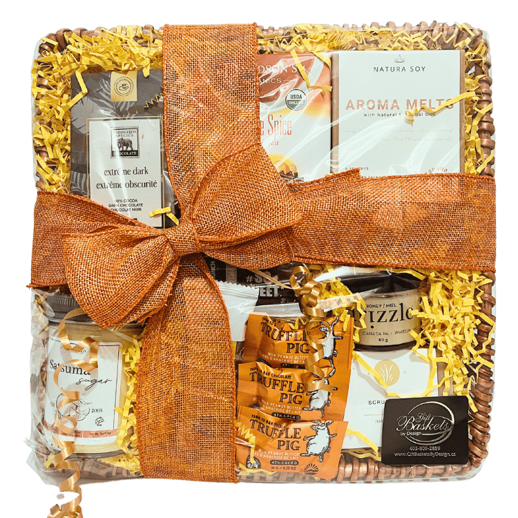 A spa gift basket containing a variety of gourmet treats and spa products, neatly arranged and tied with an orange ribbon.