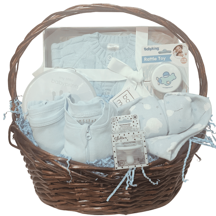 Baby Essentials Premium gift basket in blue, unwrapped, featuring baby bath items, blanket and grooming accessories arranged in a keepsake basket