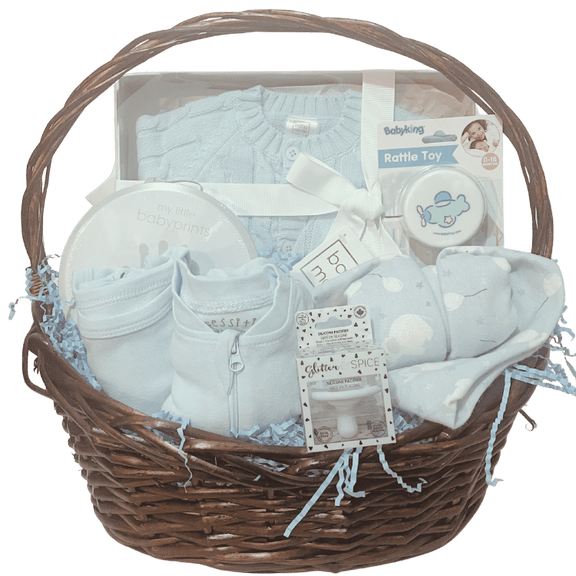 Baby Essentials Premium gift basket in blue, unwrapped, featuring baby bath items, blanket and grooming accessories arranged in a keepsake basket