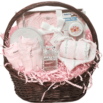 Baby Essentials Premium gift basket in pink, unwrapped, featuring baby bath items, blanket and grooming accessories arranged in a keepsake basket
