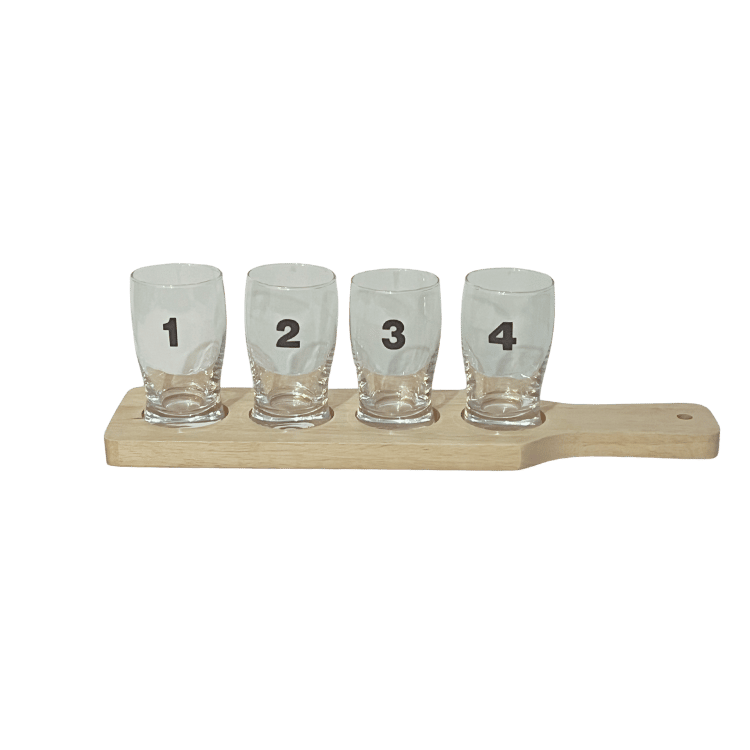 Wooden beer flight board with numbered mini glasses arranged from 1 to 4.