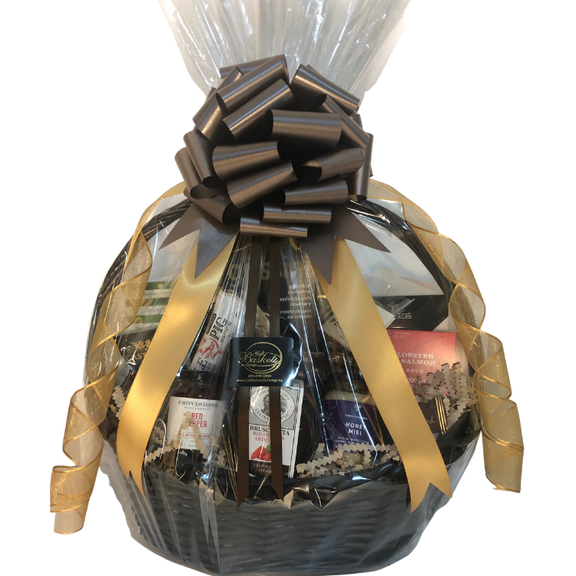 Gourmet gift basket with smoked salmon, cheese, chocolate, and artisan treats, wrapped in gold and brown neutral ribbons and bow.
