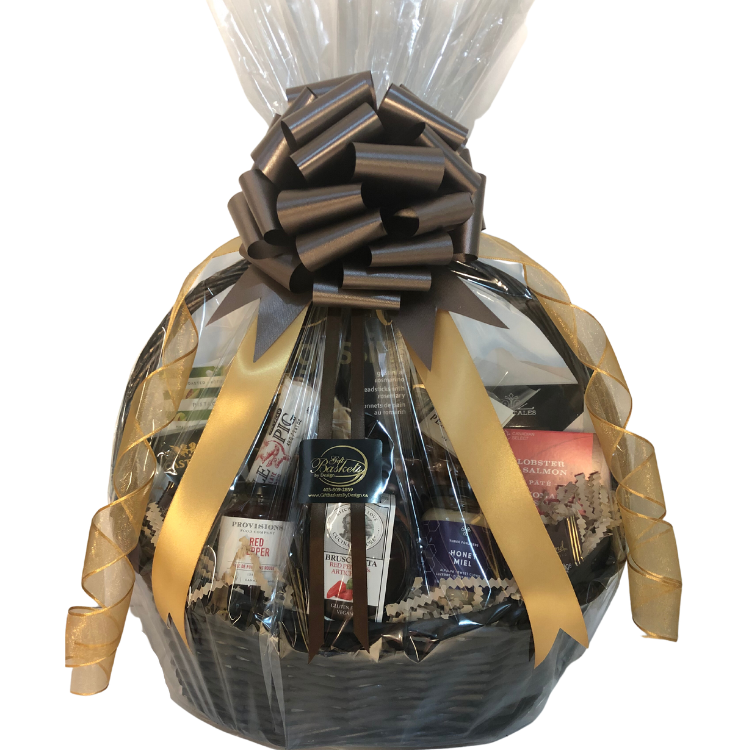 Gourmet gift basket with smoked salmon, cheese, chocolate, and artisan treats, wrapped in gold and brown neutral ribbons and bow.