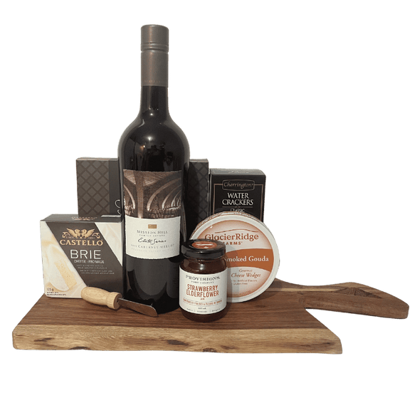 Gourmet Wine and Cheese Indulgences gift basket with wine, brie, gouda, crackers, chocolates, presented on acacia wood board.