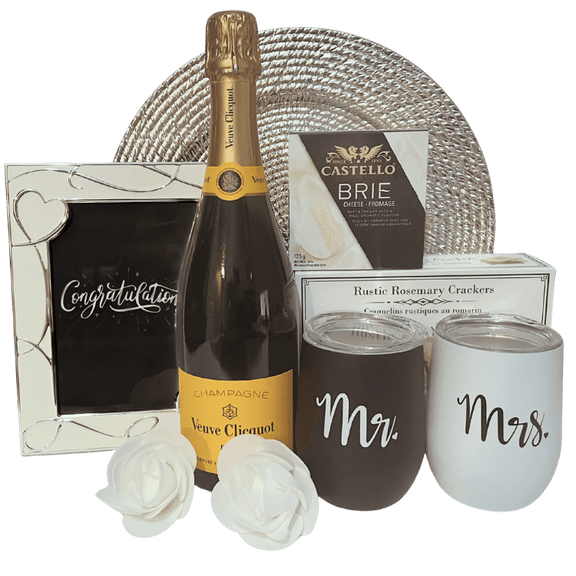 Elegant wedding celebration gift featuring Veuve Clicquot Yellow Label champagne, artisan crackers, brie cheese, personalized stainless steel wine tumblers, and keepsake frame