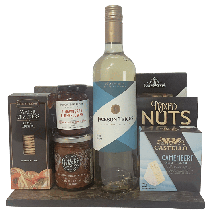 Assorted food and wine items including a bottle of Jackson Triggs white wine, crackers, cheese and snacks on a slate platter.