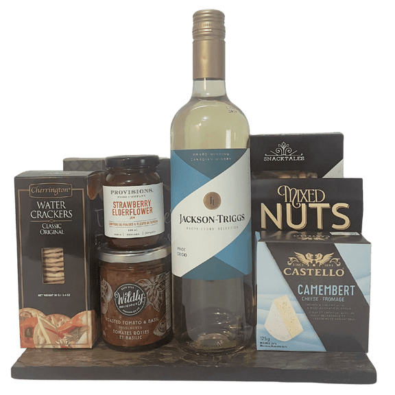 Assorted food and wine items including a bottle of Jackson Triggs white wine, crackers, cheese and snacks on a slate platter.