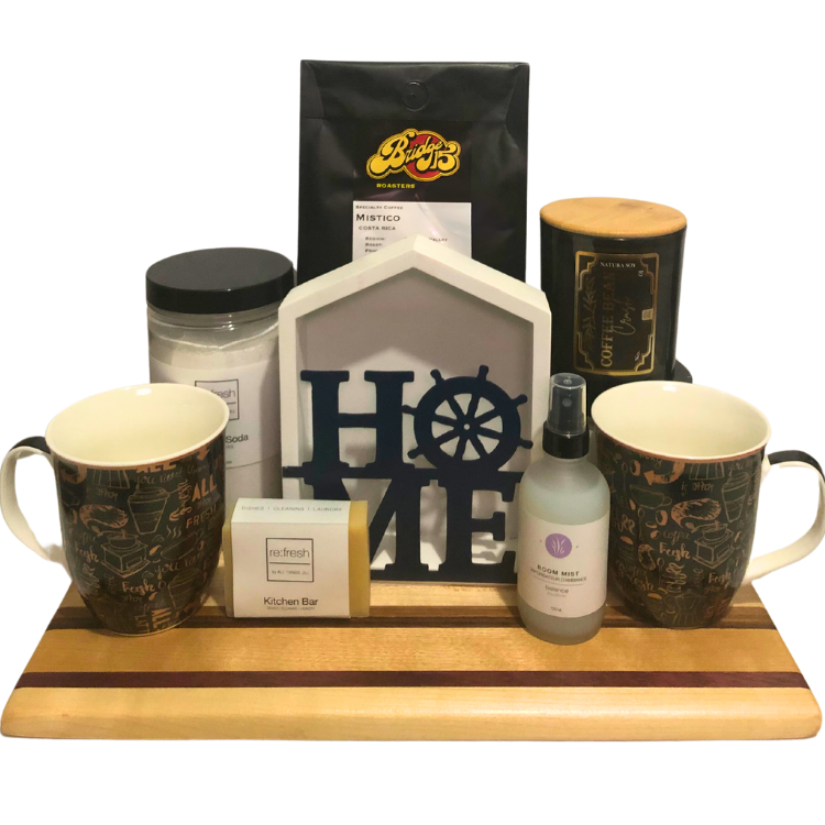 Home Sweet Home housewarming gift basket featuring local coffee, candles, room mist, serving board, and home essentials.