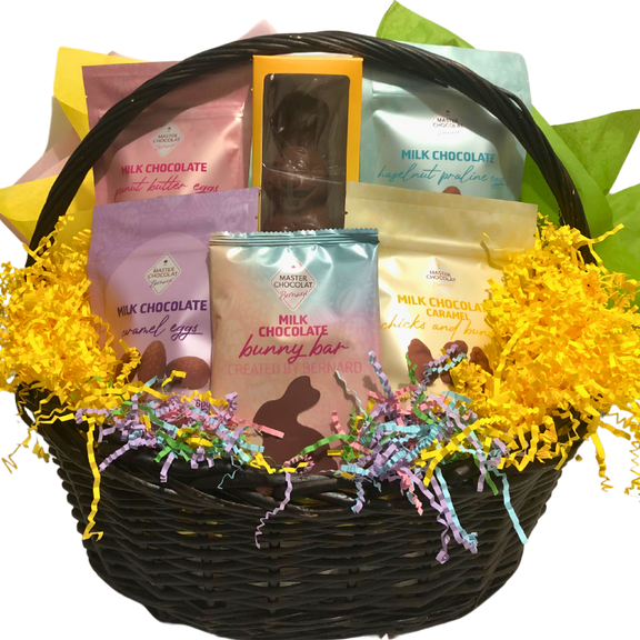 Wicker basket filled with assorted Easter chocolates in cheerful pastel wrapping.