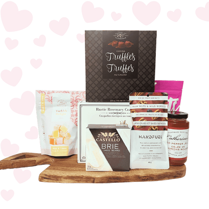 Love at First Bite Valentine’s charcuterie gift basket with gourmet crackers, brie cheese, chocolates, salmon, and sweet treats, beautifully packaged for Valentine’s Day