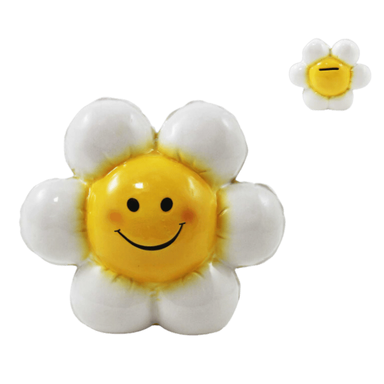 Smiley face daisy flower ceramic money bank with cheerful design, displayed as a playful gift basket add-on.
