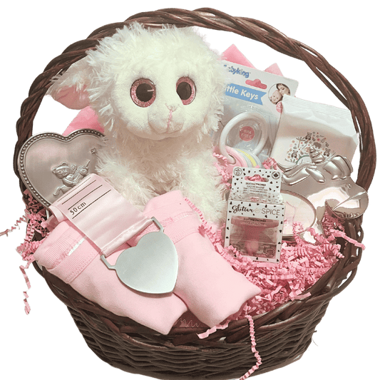 Unwrapped view: pink basket contents displayed including plush lamb, bodysuits, rattle, pacifier, wipes, frame, and growth chart