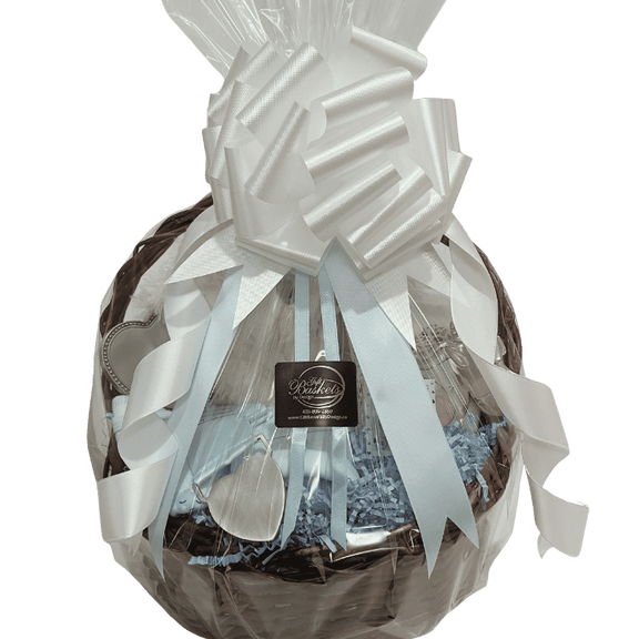 Blue version wrapped: Sparkle Eyes baby gift basket with blue ribbon, plush lamb, and baby keepsakes